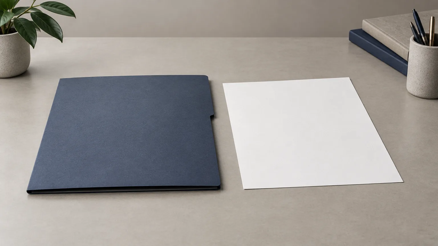 A plain closed folder and blank sheet on a neutral desk.